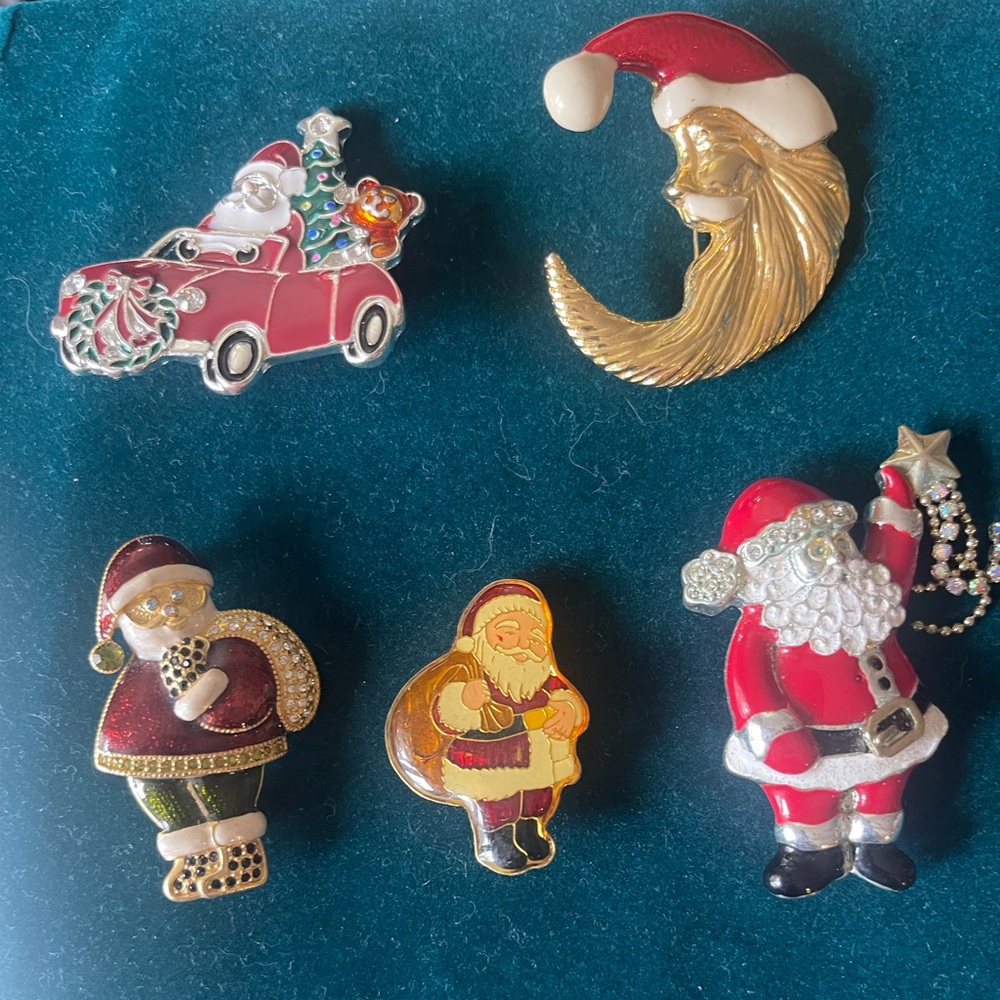 Set of five festive vintage santa Christmas pins.